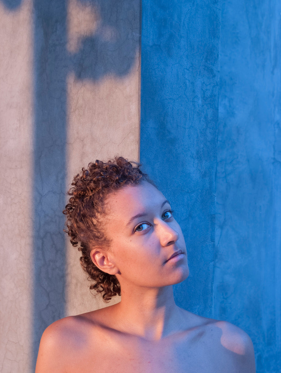 Woman standing next to wall