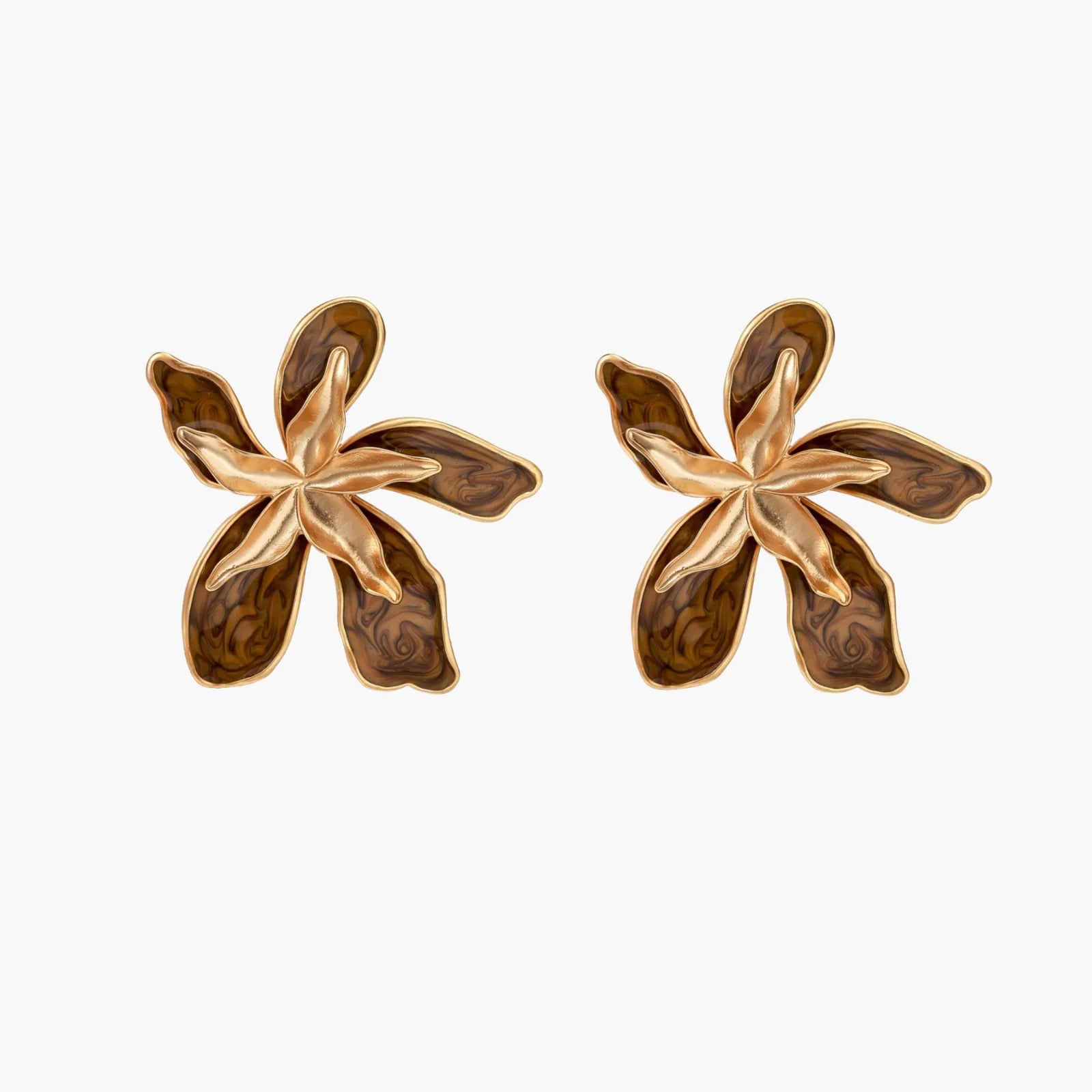 Gold-plated brass flower earrings with brown tortoiseshell enamel petals on cream background