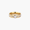 Gold-plated double-band ring with center rhinestone solitaire and channel-set stones on white background