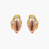 Gold-plated baroque stud earrings with coral-pink liuli stones and cubic zirconia crystals on white background.